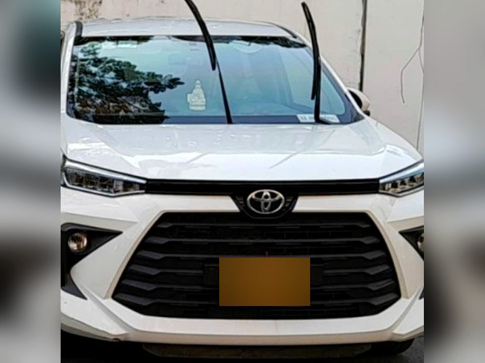 White Toyota Veloz private car waiting for travellers in Vietnam